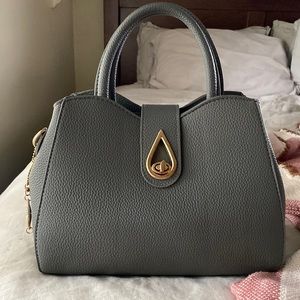 Gray faux leather handbag with gold color accents